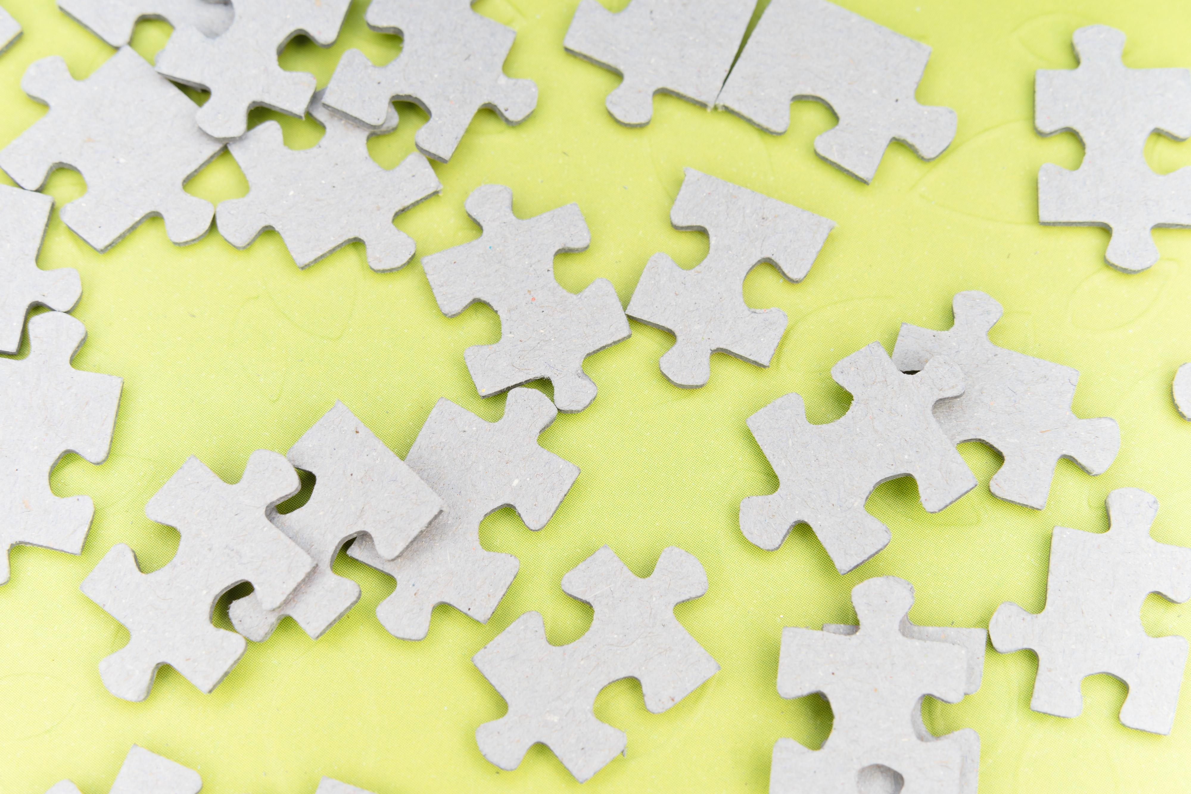 Cardboard puzzle pieces on a yellow background