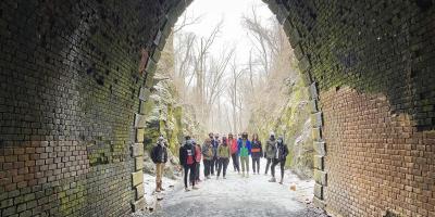 A group of students stands in the Blue Ridge Tunnel.