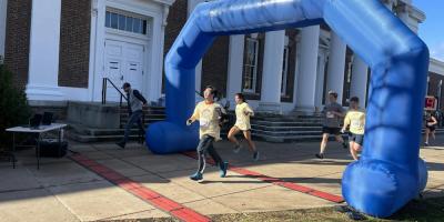 Student Running Through the Finish Line