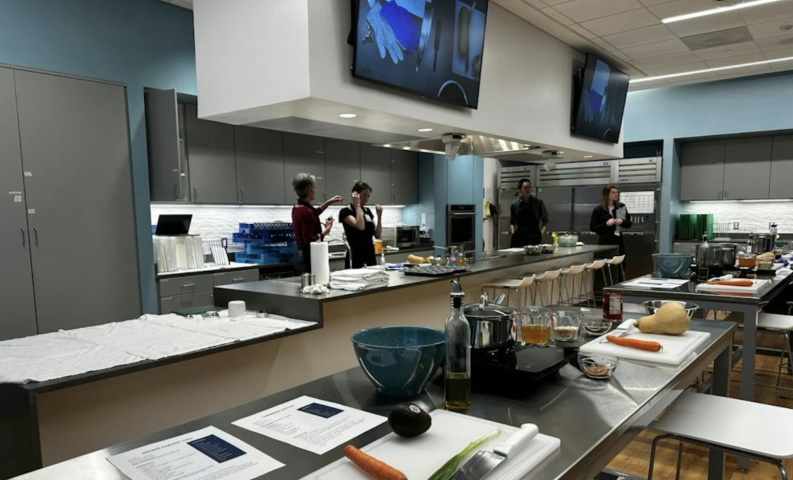 Student and Instructor get ready to lead a class in the Teaching Kitchen