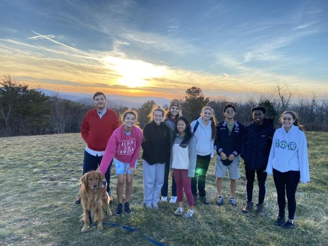 students posing at sunset in nature
